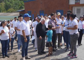 Foto de un cura con comunidad alrededor