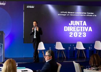 Foto de una persona presentando un tema a varios conferencistas