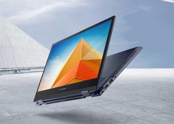 Foto de un computador con la pantalla entreabierta con un fondo gris
