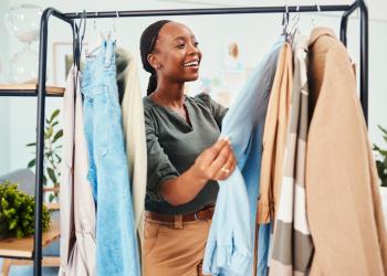 Foto de una mujer mirando ropa de diferentes tonalidades y estilos