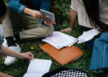 tres personas sentadas estudiando 
