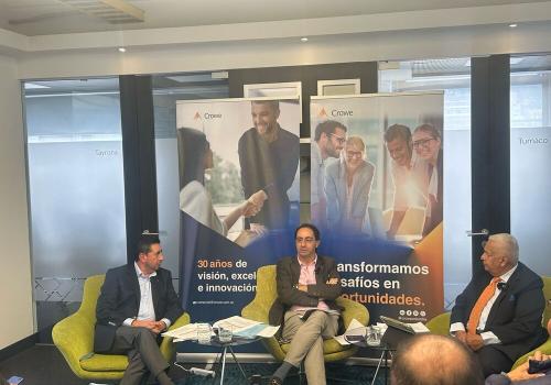 Foto de tres personas reunidas en una sala