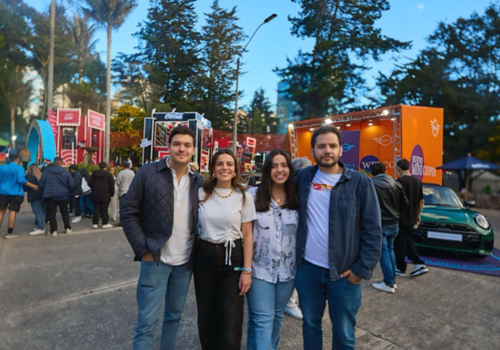 Foto de cuatro personas con un fondo de festival